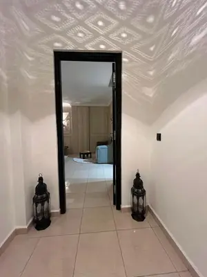 a hallway with a doorway into a room with a ceiling at Amjad in Marrakech