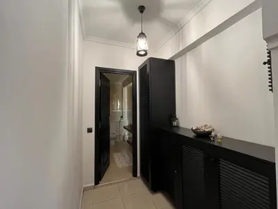 a hallway with a black cabinet and a bathroom at Amjad in Marrakech