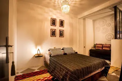 a bedroom with a bed with two pillows on it at Loft house Marrakech in Marrakech