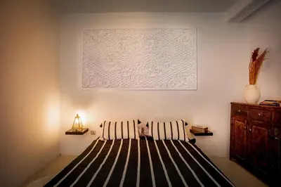 a bed in a room with a picture on the wall at Loft house Marrakech in Marrakech