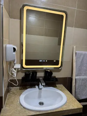 a bathroom with a sink with a mirror and aounter sidx sidx sidx at Hotel-Style Studio - High speed internet - Parking in Marrakech