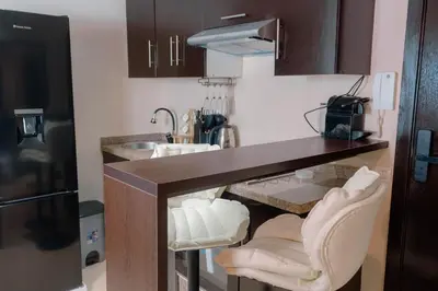 a kitchen with a counter with two chairs and a sink at Hotel-Style Studio - High speed internet - Parking in Marrakech