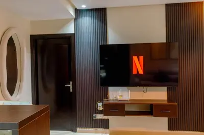 a living room with a tv on a wall at Hotel-Style Studio - High speed internet - Parking in Marrakech