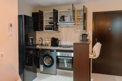 a kitchen with a stove and a washer and dryer at Hotel-Style Studio - High speed internet - Parking in Marrakech