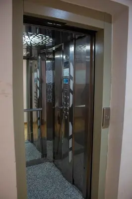 an elevator in a building with glass doors at Hotel-Style Studio - High speed internet - Parking in Marrakech