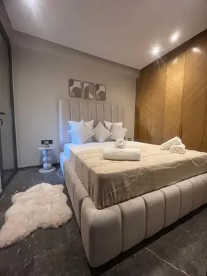 a bedroom with a large bed with a large white bedspread at Appartement cosy près de Gueliz in Marrakech