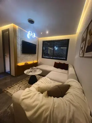 a living room with two white couches and a tv at Appartement cosy près de Gueliz in Marrakech