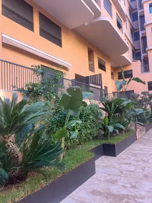 a building with plants next to a sidewalk at Appartement cosy près de Gueliz in Marrakech