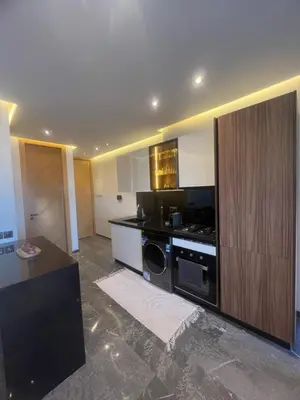 a kitchen with a stove and a dishwasher at Appartement cosy près de Gueliz in Marrakech