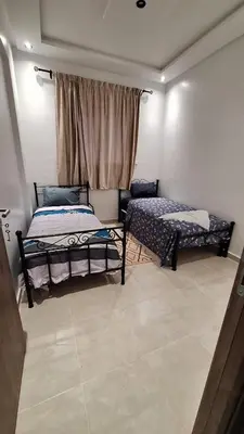 a bedroom with two beds and a window at Spacious Apartment with AC & Fast WiFi 5 Guests in Marrakech