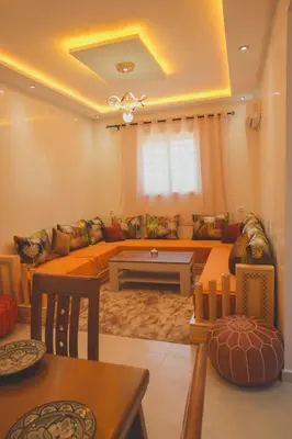 a living room with a couch and a table at Spacious Apartment with AC & Fast WiFi 5 Guests in Marrakech