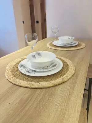 a table with two plates and wine glasses on it at Appartement vue piscine & fitness à Guéliz in Marrakech