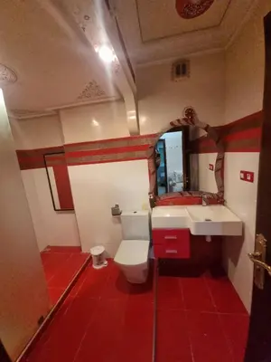 a bathroom with a toilet and a sink and a mirror at Appartement Laila Guéliz - Victor Hugo in Marrakech