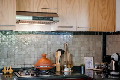 a kitchen counter with a pot on a stove at Stylish Apartment with Pool in Marrakech in Marrakech