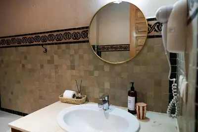a bathroom with a sink and a mirror on a counter at Stylish Apartment with Pool in Marrakech in Marrakech