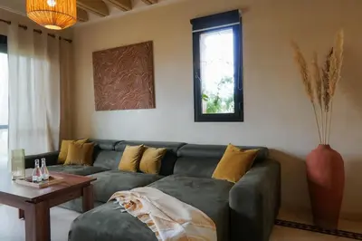 a living room with a couch and a table at Stylish Apartment with Pool in Marrakech in Marrakech