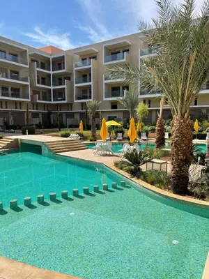 an empty swimming pool in front of a hotel at Duplex High Standing-0 Fees Service-10 min Gueliz in Marrakech
