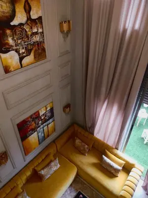 a living room with a couch and a window at Duplex High Standing-0 Fees Service-10 min Gueliz in Marrakech
