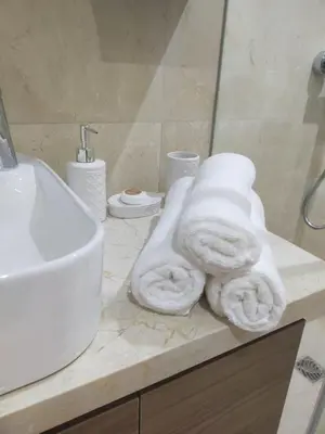 a bathroom with a sink and towels on a counter at Duplex High Standing-0 Fees Service-10 min Gueliz in Marrakech