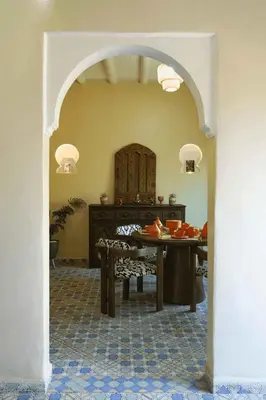an archway leading to a dining room with a table at Berber House Authentic Moroccan Farm Stay in El Rhechat