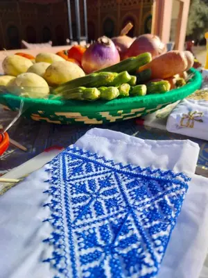 a table with two plates of fruit and vegetables on it at Chamali House Peaceful Nature Farm Stay Ferme Zarraba in El Rhechat