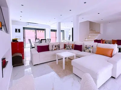 a living room with a white couch and a table at Villa nakhil in Marrakech