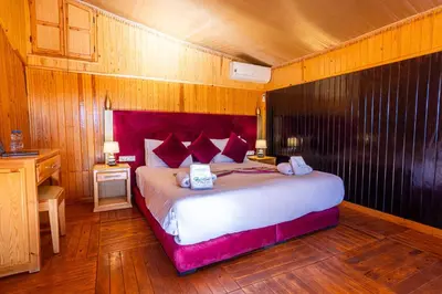 a bedroom with a large bed in a room at Ferme dhôte Sidi Safou Cabane en bois Marrakech in Marrakech