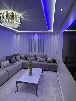 a living room with a couch and a table at prestige 2 bedroom appartment in Marrakesh in Marrakech