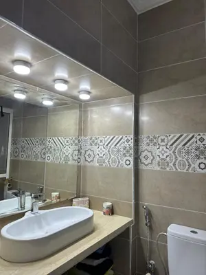 a bathroom with a sink and a mirror and a toilet at prestige 2 bedroom appartment in Marrakesh in Marrakech