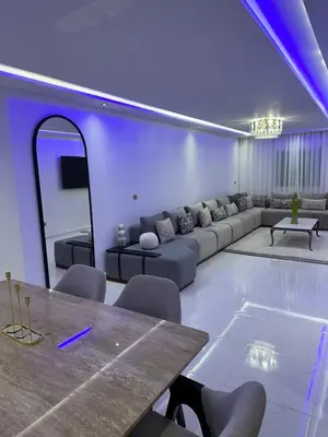 a living room with a couch and a table at prestige 2 bedroom appartment in Marrakesh in Marrakech