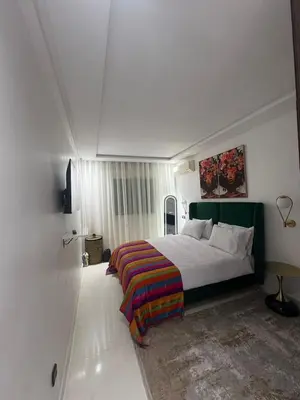 a bedroom with a bed with a colorful blanket at prestige 2 bedroom appartment in Marrakesh in Marrakech