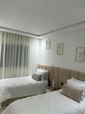 a bedroom with two beds and a window at prestige 2 bedroom appartment in Marrakesh in Marrakech