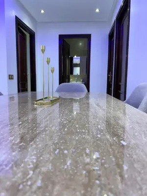 a large marble table in a room with purple walls at prestige 2 bedroom appartment in Marrakesh in Marrakech