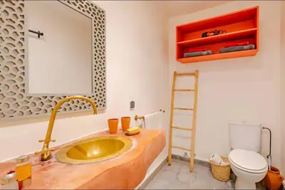 a bathroom with a sink and a toilet and a mirror at Villa MyMa in Marrakech