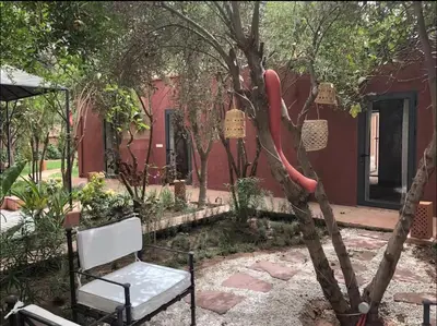 a chair and a hot dog hanging from a tree at Villa MyMa in Marrakech