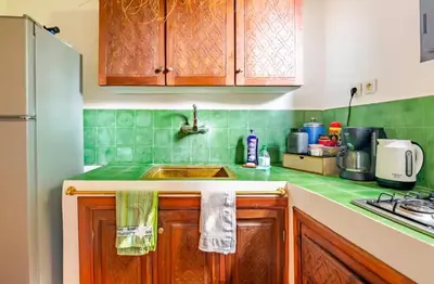 a kitchen with wooden cabinets and a sink at Villa MyMa in Marrakech