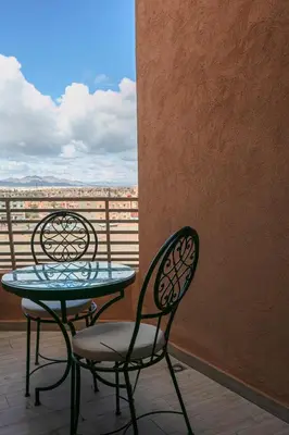 two chairs and a table on a balcony at 2 bedroom apartment, 4 people, near Jardin Majorelle in Marrakech
