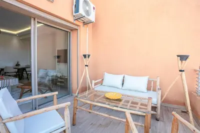 a patio with a couch and a table and chairs at 2 bedroom apartment, 4 people, near Jardin Majorelle in Marrakech