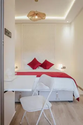 a bedroom with a bed with red pillows and a chair at 2 bedroom apartment, 4 people, near Jardin Majorelle in Marrakech