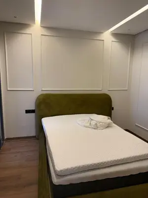 a small room with a bed with a white mattress at Résidence haut standing Piscine Fitness Marrakech in Marrakech