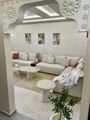 a living room with a couch and a table at Charmant cocon moderne in Marrakech