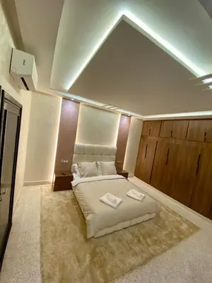 a bedroom with a bed with two towels on it at Charmant cocon moderne in Marrakech