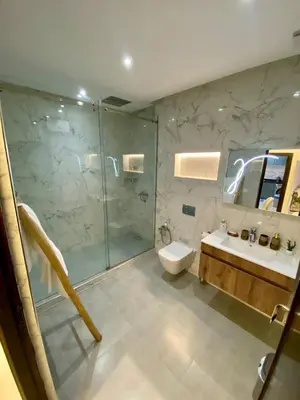 a bathroom with a shower and a toilet and a sink at Charmant cocon moderne in Marrakech