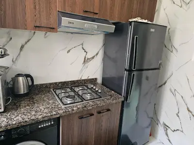 a kitchen with a refrigerator and a stove at مراكش in Marrakech