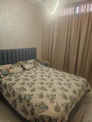 a bedroom with a bed with a floral blanket at مراكش in Marrakech