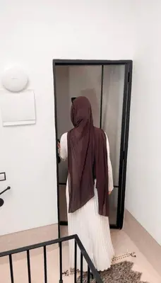a woman wearing a hijab standing in a elevator at Stunning penthouse in city center in Marrakech