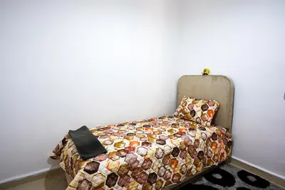 a bedroom with a bed and a pillow and a wall at apartment in Hay mabrouka gueliz Marrakech in Marrakech