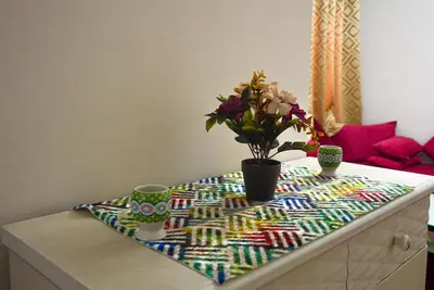 a table with flowers and cups on top of it at apartment in Hay mabrouka gueliz Marrakech in Marrakech