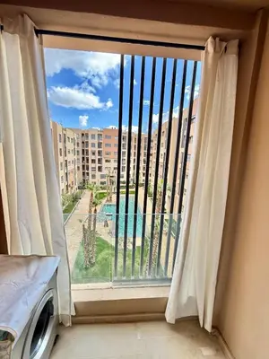 a window with a view of a building at Stylish and cozy accommodation for families in Marrakech