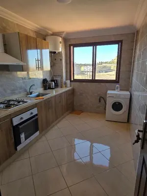 a kitchen with a sink and a washing machine at Appartement Lady Plaza 3 in Marrakech